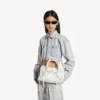Damen-Tasche „Le City“ klein mit riesigen Nieten und Strasssteinen in Optikweiß Damen-Tasche „Le City“ klein mit riesigen Nieten und Strasssteinen in Optikweiß